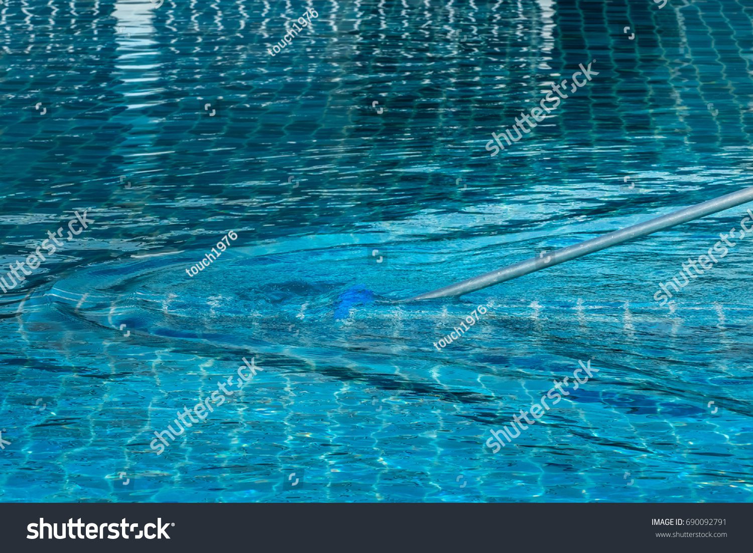 stock-photo-cleaning-the-swimming-pool-690092791 Garnet Residence